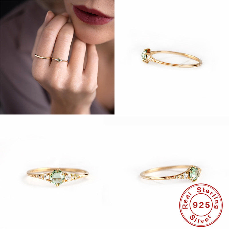 Women's rings are fashionable and luxurious accessories, shown in multiple angles with a green gemstone and 925 sterling silver hallmark.