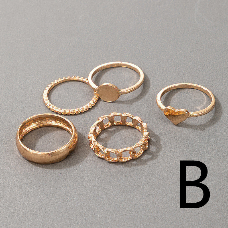 Geometric Circle Gold Rings Set B featuring five alloy rings in modern designs including heart, chain, and textured styles for stackable wear.
