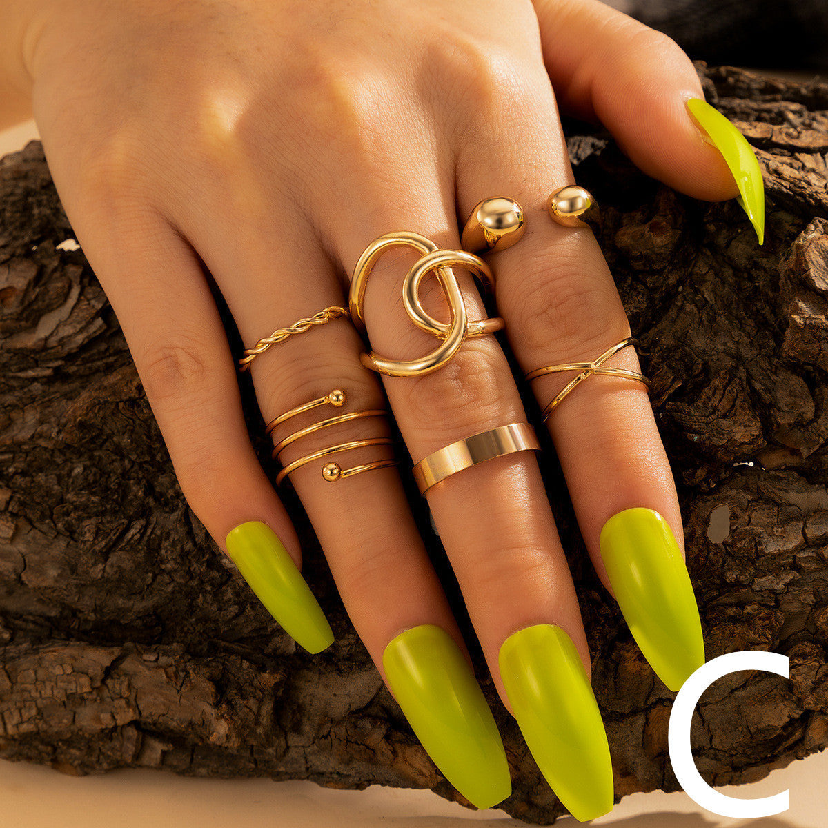 Geometric Circle Gold Rings Set featuring multiple alloy rings in modern geometry style, worn on hand with neon green nails for bold fashion appeal.