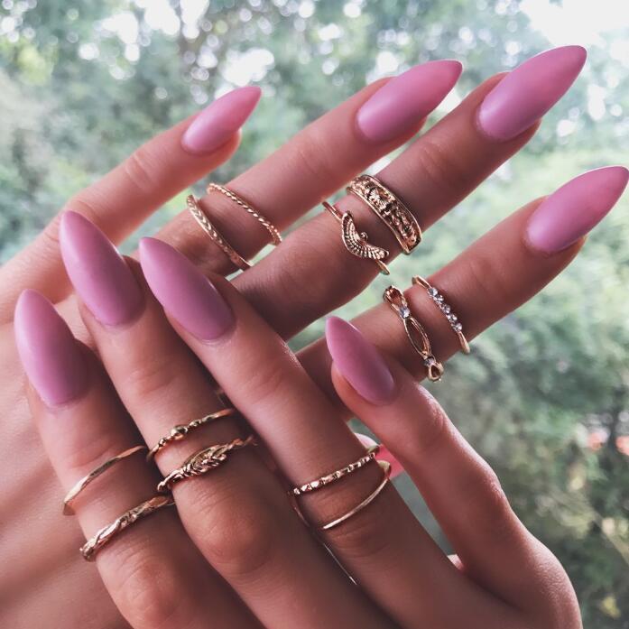 Geometric Circle Gold Rings Set featuring multiple stackable alloy rings in modern geometry style, worn on manicured hands with pink nails.